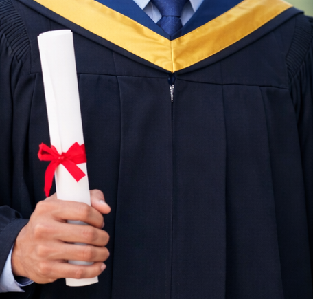Graduate smiling in graduation attire for Learning Management